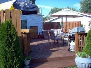 Custom deck with built in hot tub overlooks park-like yard
