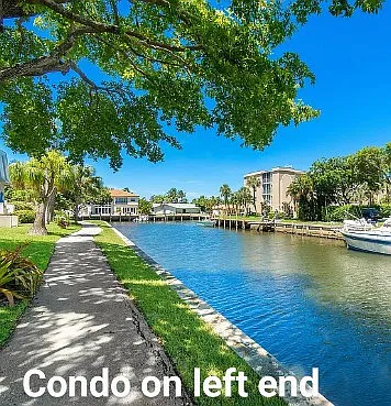 View of one of the walkways that go around the building complex along the canals. The condo is at the end of this canal on the left hand side.