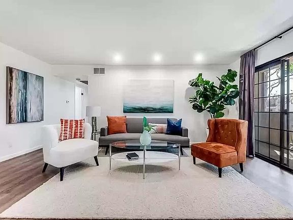 Living room with hardwood vinyl flooring (if furnished) with recessed lights and black-out curtains