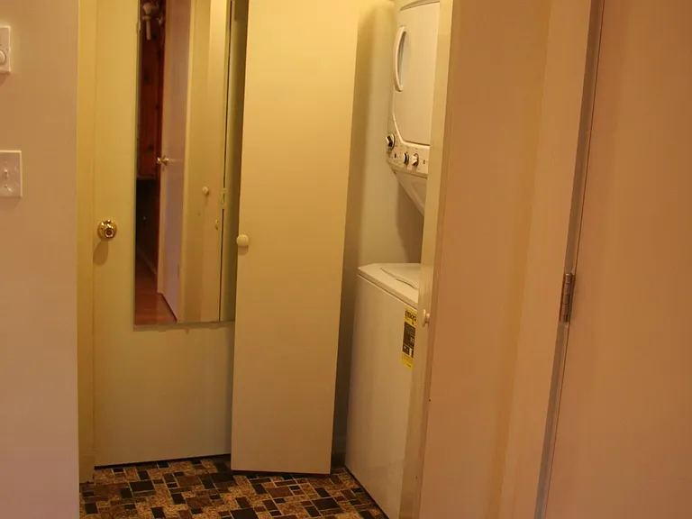 The folding doors house a clothes closet and stackable washer/dryer.
Mirrored door opens into a full-size bathroom with ample storage. A large wardrobe in the garage provides additional storage for out of season clothes and suitcases.
