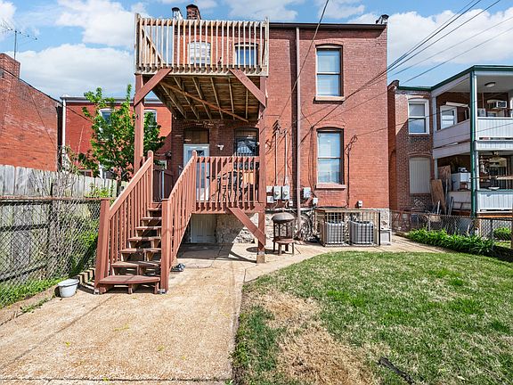 Rear of property. Private second floor deck. Fenced yard.