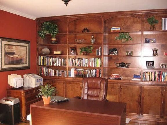 Full wall of custom cherry built in cabinets in the library / study