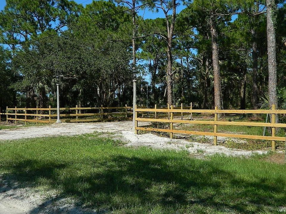 5 Acres!  Wooded, Pines, Oaks, Palms.  Antique Light Posts at the front gate.