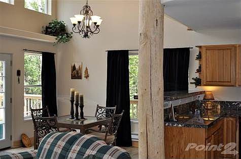 Great room with vaulted ceiling has loads of windows