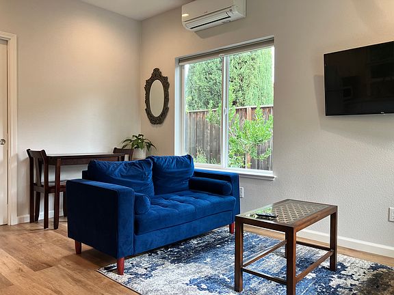 Dining area and living area adjacent to the kitchen. Top-of-the-line high efficiency ductless heater/AC units in the bedroom and living room.