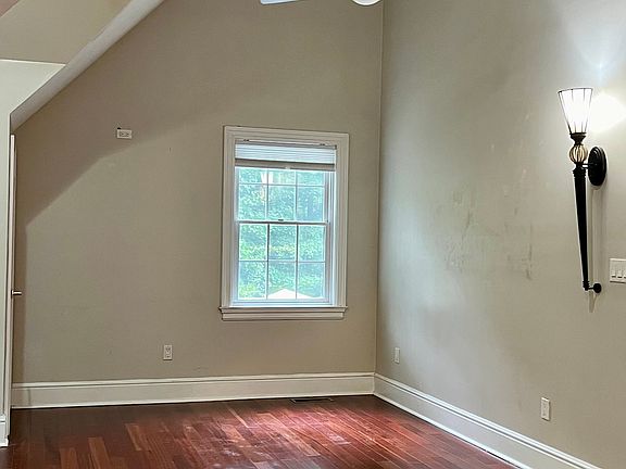 Large living room with high celings, wood floors.