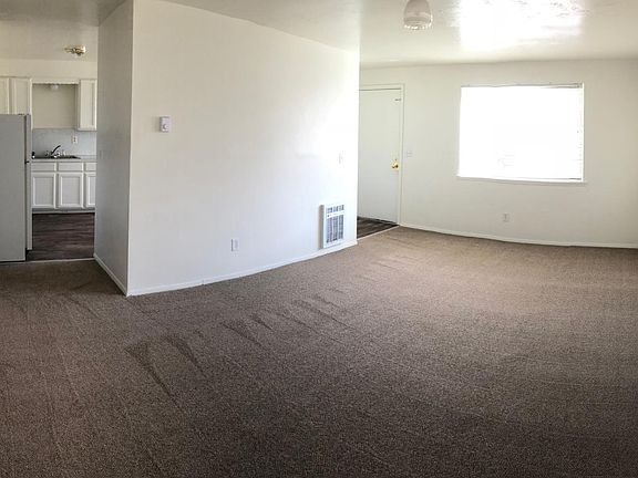 View from the far corner of the living room. Coat closet at entry. Additional storage closets in hall by bedrooms.