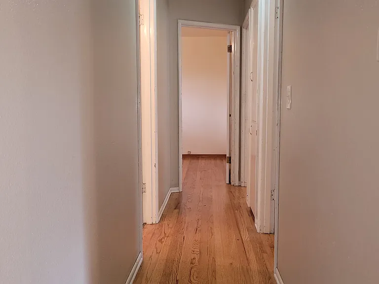 front of house hallway with 3 bedrooms, floor to ceiling linen cloest, and full bathroom