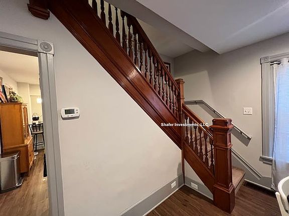 This photo showcases the original woodwork on the staircase.