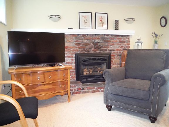 Cozy living room with new 43" TV with Roku streaming, gas fireplace, leather couch with 2 built-in recliners and comfy chair for reading