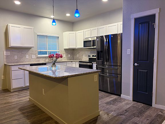Granite countertops throughout kitchen.