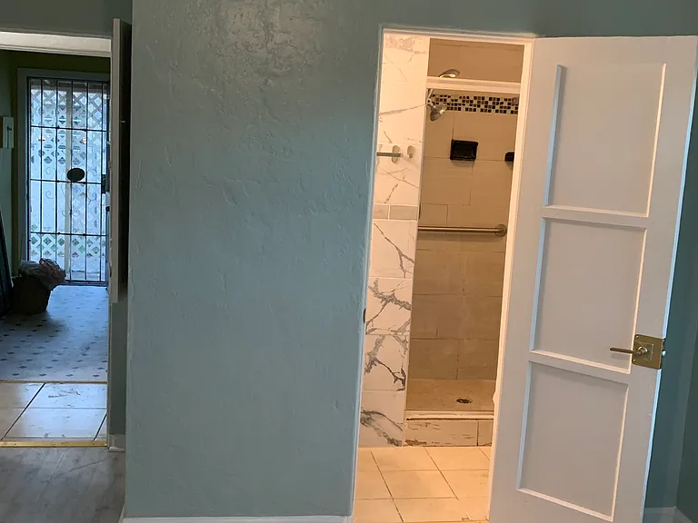 Master room view, showing entry from hallway to left and master bathroom to the right.
