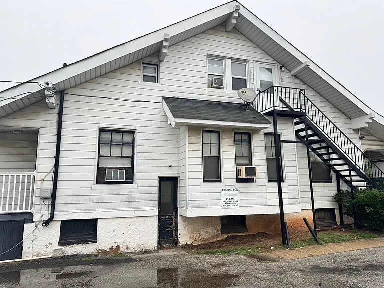 Side Entrance to Basement with Storage/Laundry Access. The far left of the photo is where the porch and main entrance for unit 1B are located.