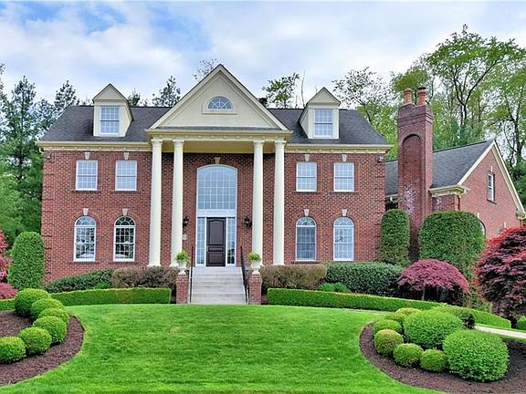Exterior Front - Exceptional custom-built home featuring six bedrooms and seven and a half baths.