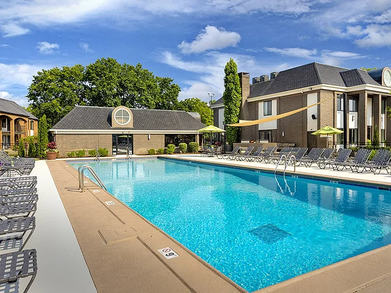 Resort-style pool and expansive sundeck with lounge seating
