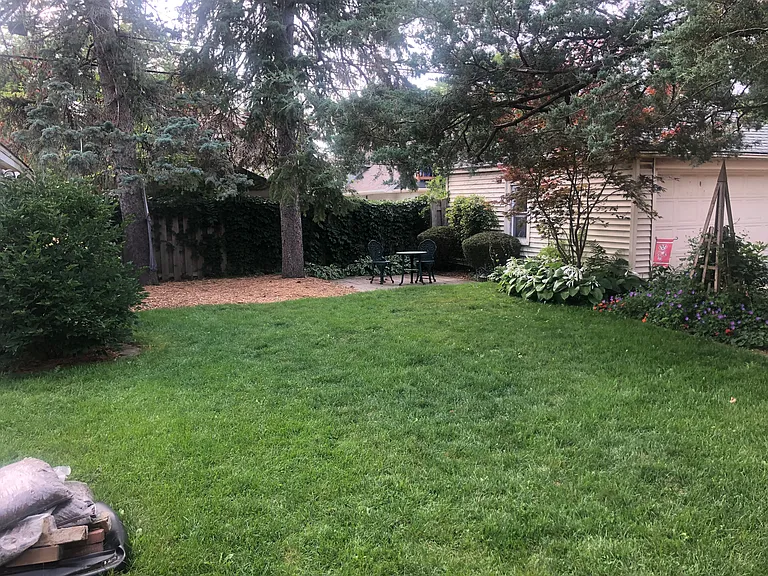 Nice sized back yard with brick patio. Too shady for vegetable garden.