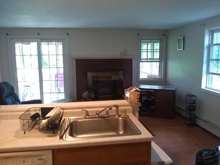 Viewing fireplace and living room from eat in kitchen