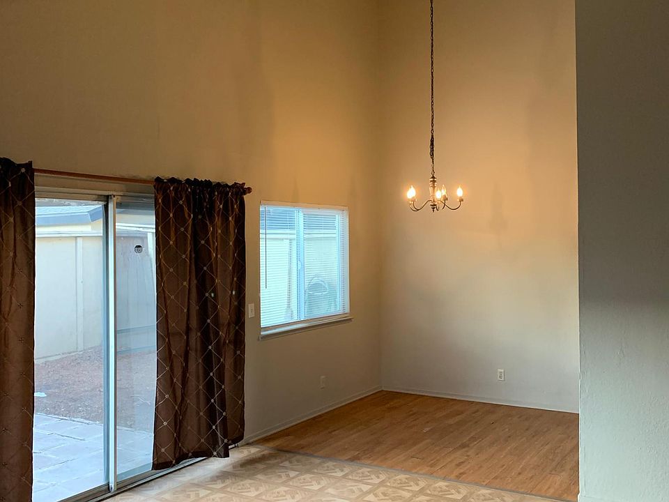 Standing by fireplace looking at dining room.