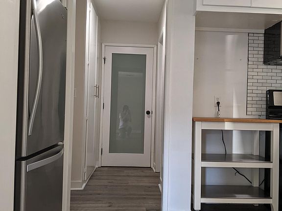 Hallway leads to one bedroom, main bathroom and storage