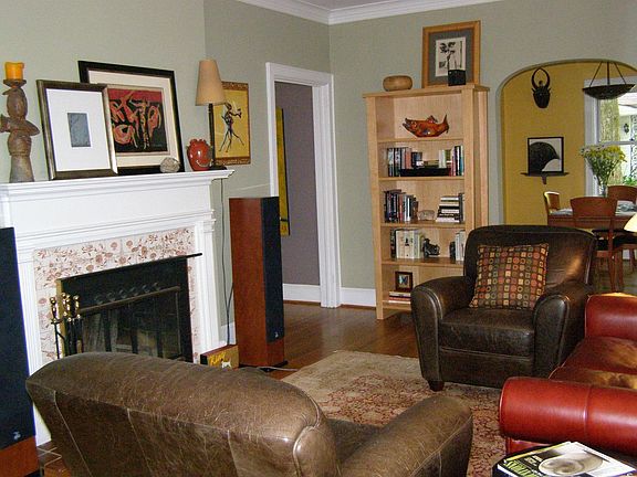 Charming living room with fireplace, 9 foot ceilings, arched doorways