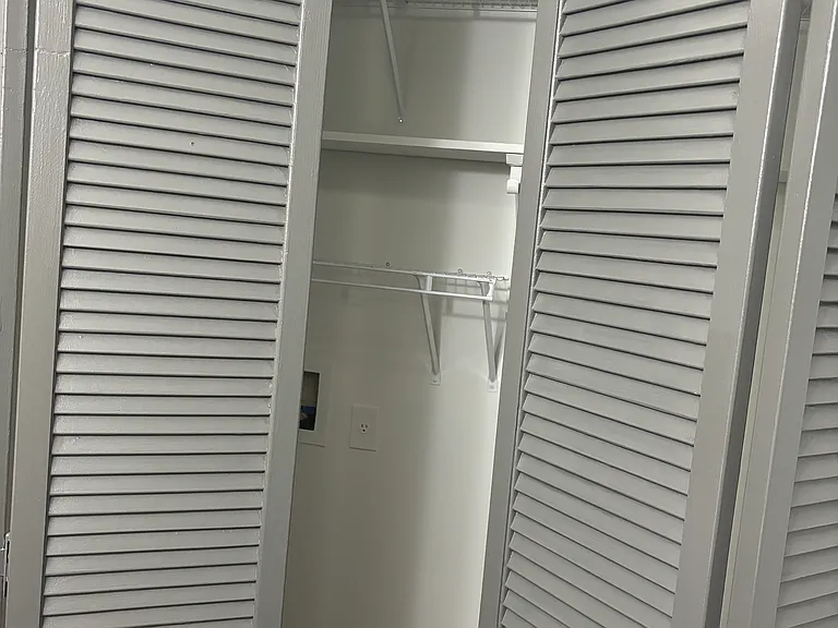 Laundry area tucked behind louvered doors