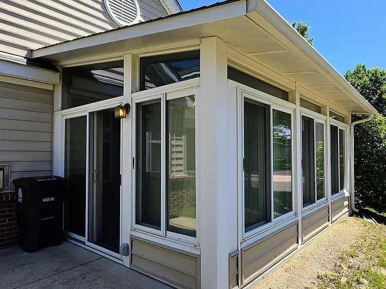 Close-up of the pristine, wrap-around sunroom enclosure_the ultimate flex space for work, fitness, or relaxation.