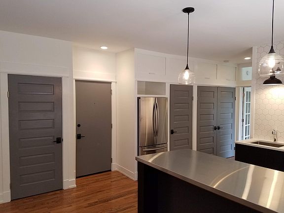 Great storage. Doors from left to right are coat closet, entry door, refrigerator, pantry, laundry/utility closet.