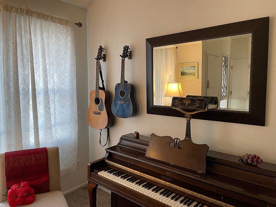 Piano, guitars, huge lovely windows, seating, "piano living room" at entrance to kitchen on right and front entrance (and second living room) on left.