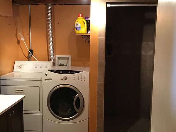 Laundry with ceramic tile shower