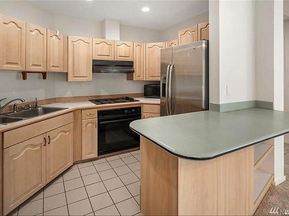 Kitchen includes new range and microwave, frig, dishwasher, and eat-in counter.