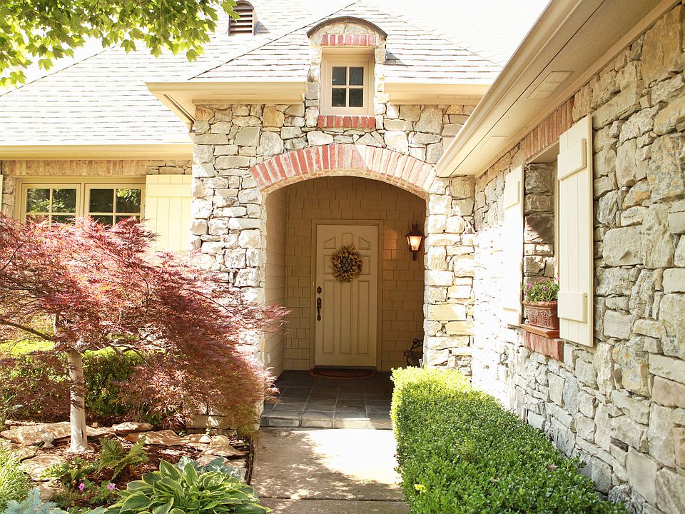 A stacked stone façade greets guests to the front entry.