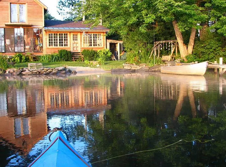 Kayaking home...
Lower, porch left/living room right.
Den behind living room and 1/2 bath, washer/dryer. 
Kitchen behind porch. Master bedroom above porch.