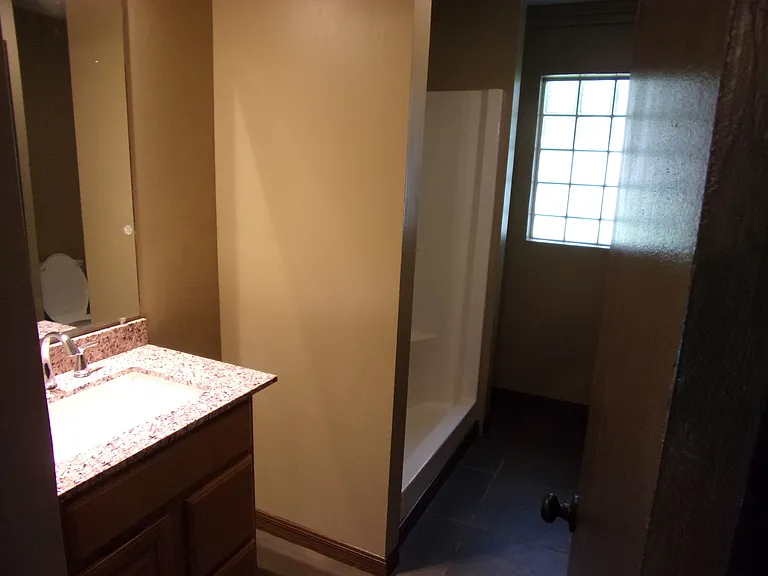 MASTER BATHROOM - GRANITE SINK - SHOWER WITH BENCH - NEW TOILET - LARGE STORAGE SHELVES BY WINDOW