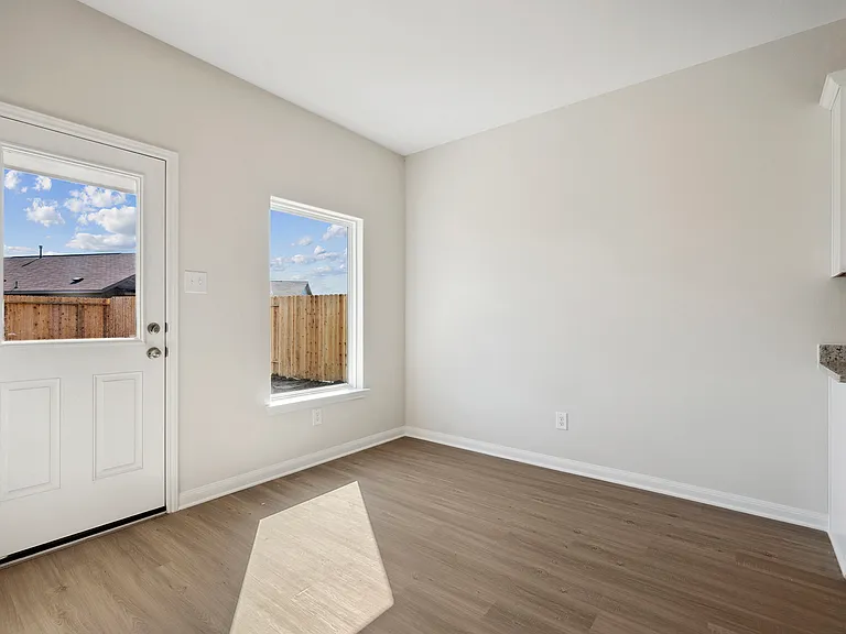 The dining room with a door to the backyard.