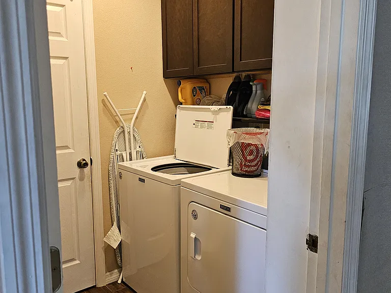 Laundry room off of Family room with door to on suite bathroom off of bedroom #2