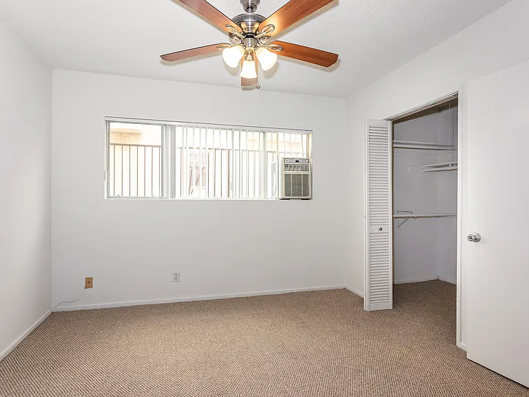 Partial view of primary bedroom. There's a big walk in closet to the right.
