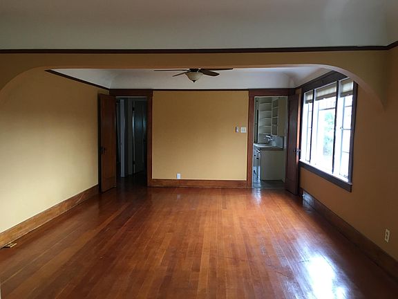 Living room/dining area. Large with south facing windows and ceiling fan.