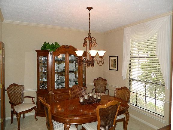 The formal dining overlooks the front gardens, It has crown and chair rail moldings and updated light fixture. Double doors leading into the kitchen can be closed off if you prefer.
