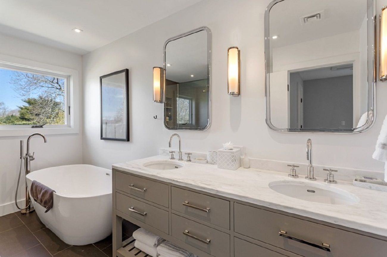 Matching Primary bathroom two with soaking tub, shower stall, double vanity granite top