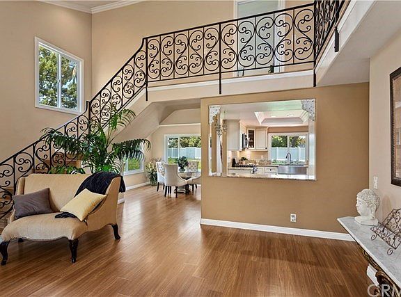 Take a look at this SPECTACULAR CUSTOM IRON STAIRCASE. The Floor Plan is Open from the Living Room, Dining Room, Kitchen and Fam
