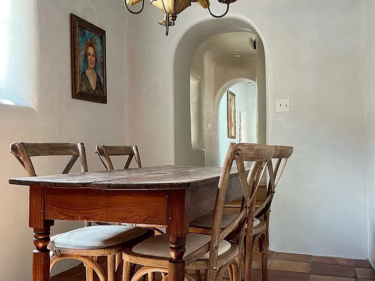 Cozy dining area with antique French harvest table
