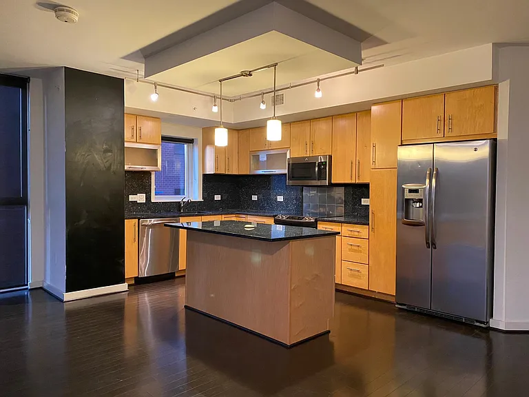 Stainless steel kitchen with blue granite & chalkboard wall