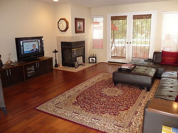 Living room with new flooring, recessed lighting and built in speakers
