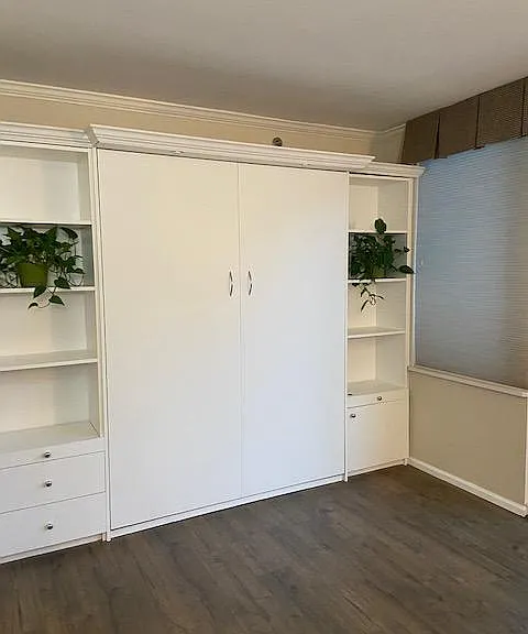 Wall bed with queen sized mattress and built-ins