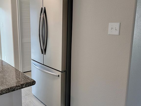 New refrigerator. Area for clothes washer and dryer off the kitchen.