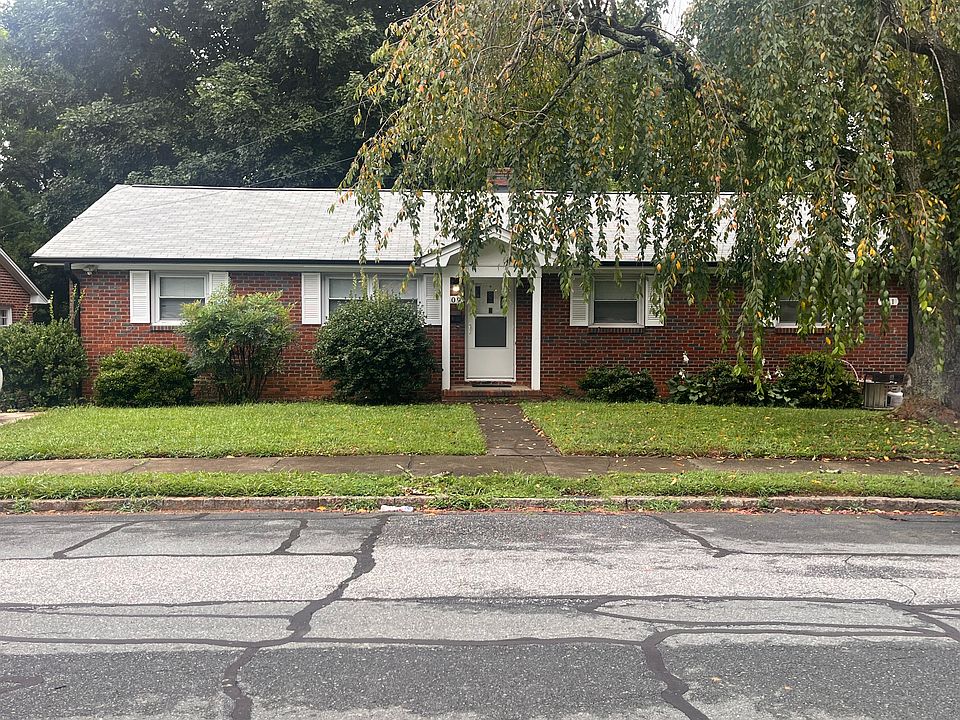 All brick duplex, this front door is the entrance to 409 Corona Street. The other unit is to the right side of the property.