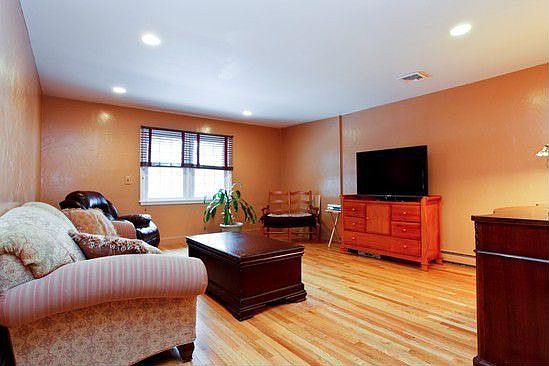 Family room with masonary fireplace behind wall