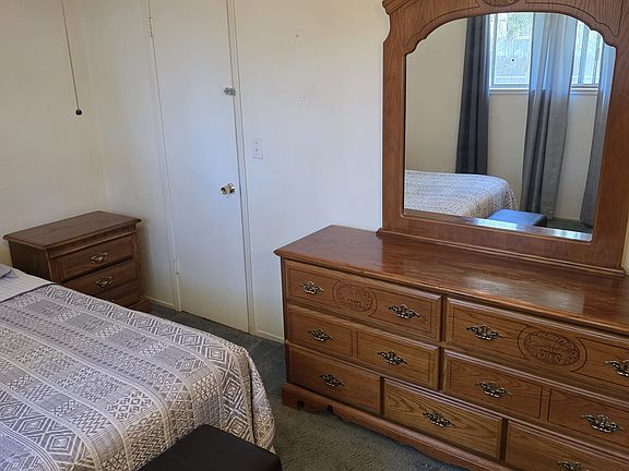 Dresser with mirror next to hallway door