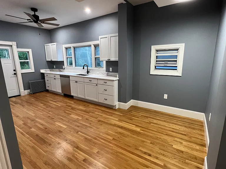 Eat-in kitchen with granite countertops and stainless steel appliances.