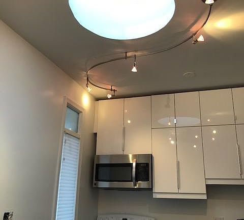 Ceiling height cabinets in kitchen. Skylight and a pantry.